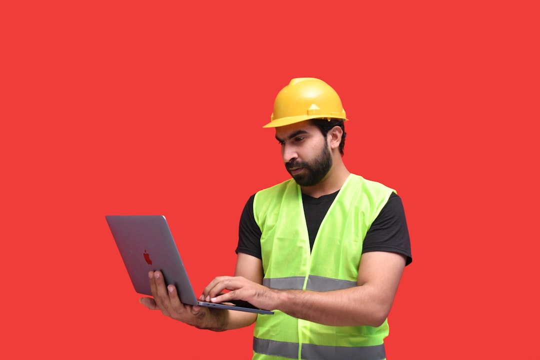 Construction project manager reviewing an AI-generated cost and programme progress report on a desktop computer